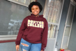 Camp Harbor View teen smiling outside and wearing a Boston College sweatshirt