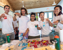 Moderna volunteers smile as they prepare to share science experiments with Boston kids.